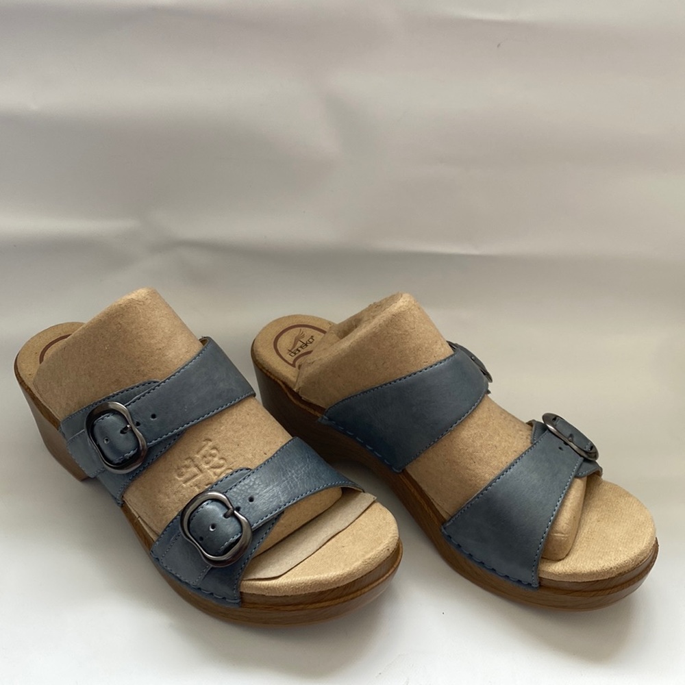 Dansko sandal double strap single stitch leather sturdy heel resembles a wedge.